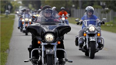 Archbishop Thomas Wenski, Miami - Florida, rode from church to church on his Harley Davidson 