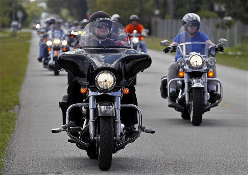 Archbishop Thomas Wenski, Miami - Florida, rode from church to church on his Harley Davidson 