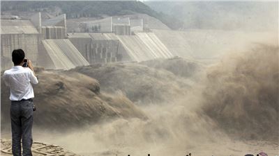 China's giant man-made waterfall as floodgates are opened to send millions of tons of silt downstream.