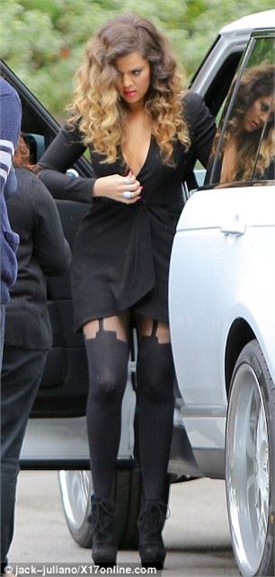 Khloe Kardashian takes the plunge in sexy wrap dress and suspender tights at hotel