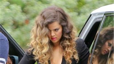 Khloe Kardashian takes the plunge in sexy wrap dress and suspender tights at hotel