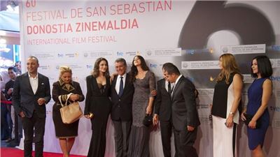 Lovely in lace: Monica Bellucci shows off her  curves at the red carpet in San Sebastian. 